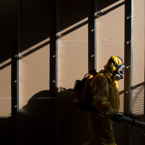 A health worker sprays insecticide to combat the Aedes aegypti mosquitoes that transmits the Zika virus under the bleachers of the Sambadrome in Rio de Janeiro, Brazil, Jan. 26, 2016. (Photo by Leo Correa/AP)