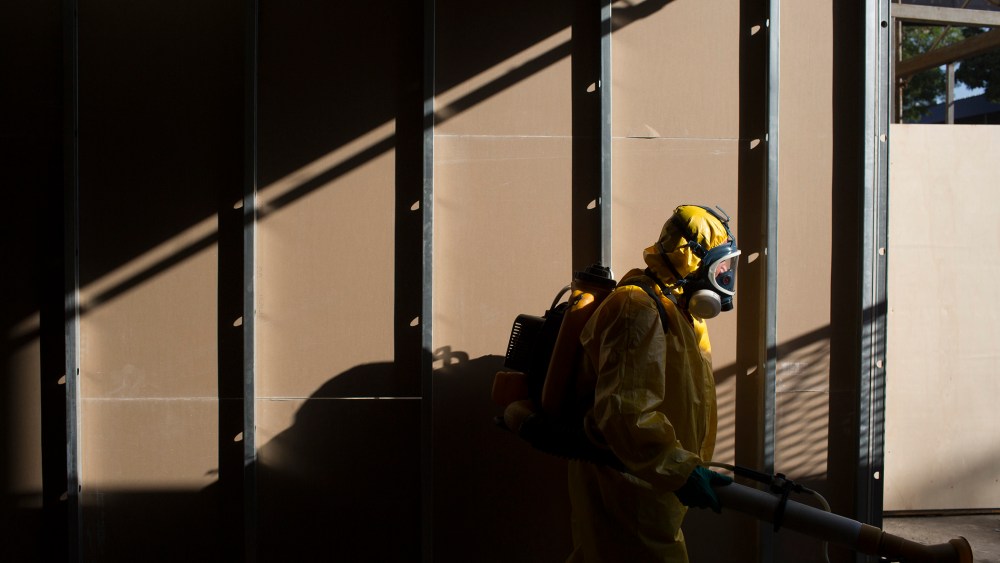A health worker sprays insecticide to combat the Aedes aegypti mosquitoes that transmits the Zika virus under the bleachers of the Sambadrome in Rio de Janeiro, Brazil, Jan. 26, 2016. (Photo by Leo Correa/AP)
