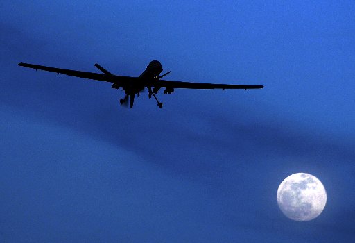A U.S. Predator drone flies over the moon above Kandahar Air Field, southern Afghanistan. (Photo by Kirsty Wigglesworth/AP)