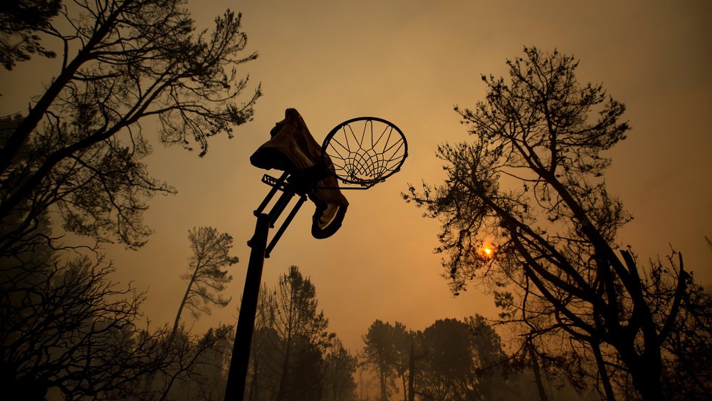 A melted basketball hoop is seen in a clearing after the Loma fire tore along a ridge top on Sept. 27, 2016 near Morgan Hill, Calif. (Photo by Noah Berger/AP)