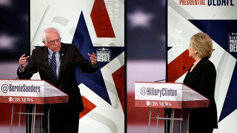 Bernie Sanders, left, makes a point as Hillary Rodham Clinton listens during a Democratic presidential primary debate, Nov. 14, 2015, in Des Moines, Iowa. (Photo by Charlie Neibergall/AP)