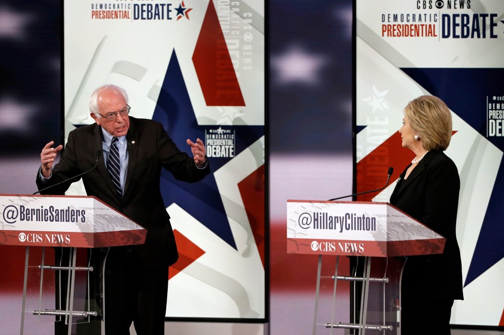 Bernie Sanders, left, makes a point as Hillary Rodham Clinton listens during a Democratic presidential primary debate, Nov. 14, 2015, in Des Moines, Iowa. (Photo by Charlie Neibergall/AP)