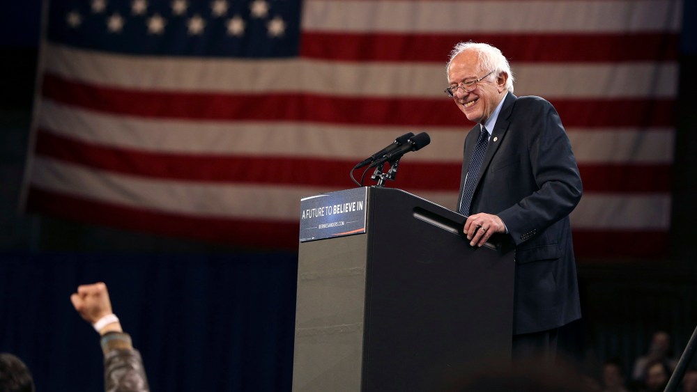 Democratic presidential candidate, Sen. Bernie Sanders, I-Vt., reacts to a fist waving supporter as he speaks at a campaign rally, April 11, 2016, in Buffalo, N.Y. (Photo by Mel Evans/AP)