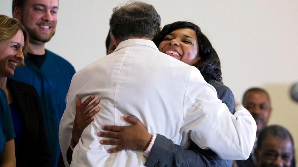 Amber Vinson, embraces Emory University Hospital epidemiologist Dr. Bruce Ribner, as she leaves a press conference after being discharged from the hospital, on Oct. 28, 2014, in Atlanta.