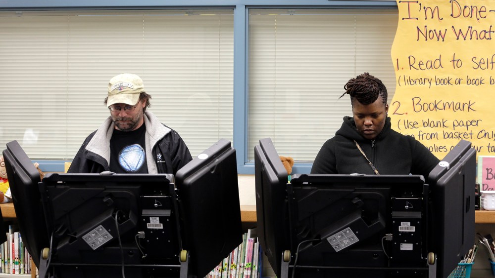 Rich Baranowski, left, and Tracy Hardy vote in Ferguson's municipal election, April 7, 2015, in Ferguson, Mo. (Photo by Jeff Roberson/AP)