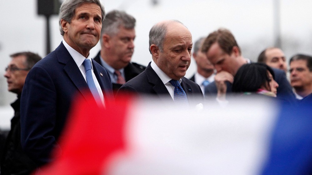 U.S. Secretary of State John Kerry, left, and French Foreign Minister Laurent Fabius visit a kosher market where four hostages were killed in a terrorist attack last Friday in Paris, on Jan. 16, 2015.