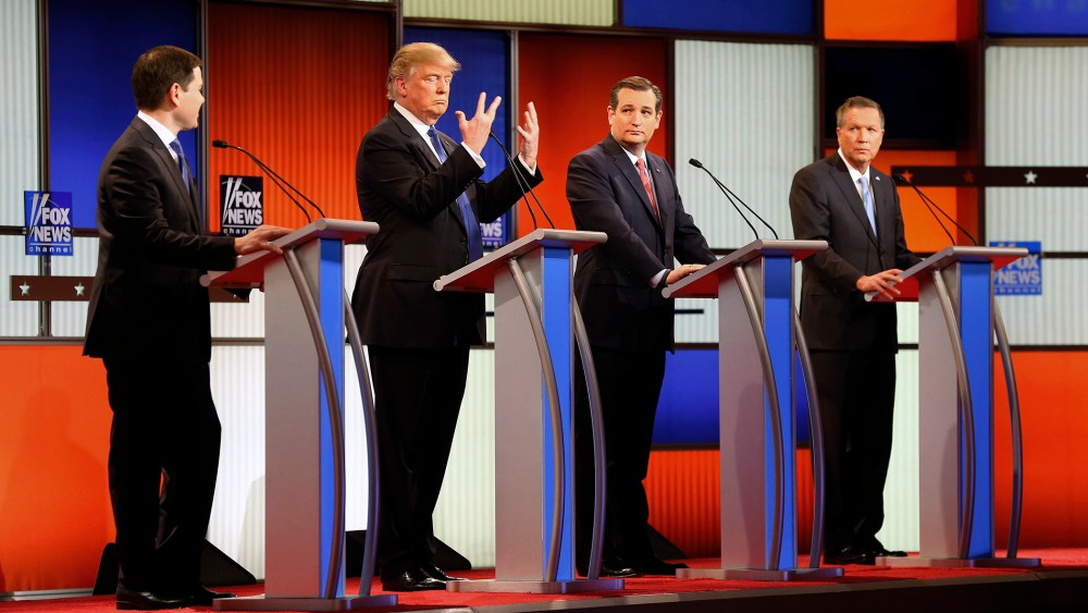 Republican presidential candidate Donald Trump, second from left, gestures as Sen. Marco Rubio, R-Fla., Sen. Ted Cruz, R-Texas, and Ohio Gov. John Kasich watch him during the a Republican presidential primary debate in Detroit. (Photo by Paul Sancya/AP)