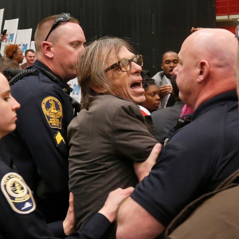 Photojournalist Christopher Morris is escorted by police during the rally of Republican presidential candidate, Donald Trump, Feb. 29, 2016, at Radford University in Radford, Va. (Photo by Steve Helber/AP)