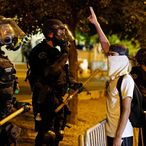 Riot police block off the Albuquerque Convention Center to anti-Trump protests following a rally and speech by Republican presidential candidate Donald Trump in Albuquerque, N.M., May 24, 2016. (Photo by Brennan Linsley/AP)