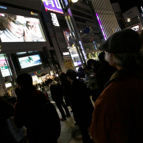 A giant TV monitor shows Junko Ishido, mother of Japanese journalist Kenji Goto who was taken hostage by the Islamic State group, in Tokyo, on Jan. 23, 2015.