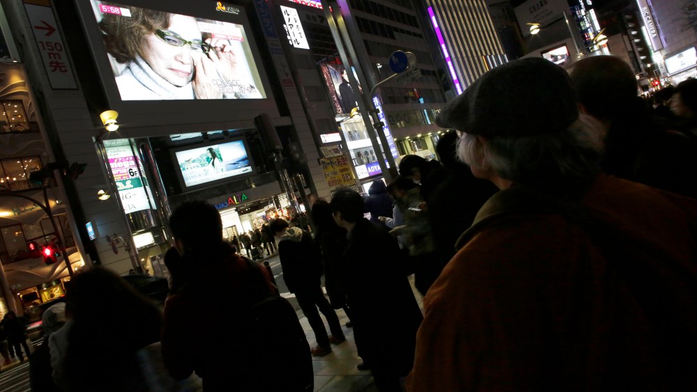 A giant TV monitor shows Junko Ishido, mother of Japanese journalist Kenji Goto who was taken hostage by the Islamic State group, in Tokyo, on Jan. 23, 2015.