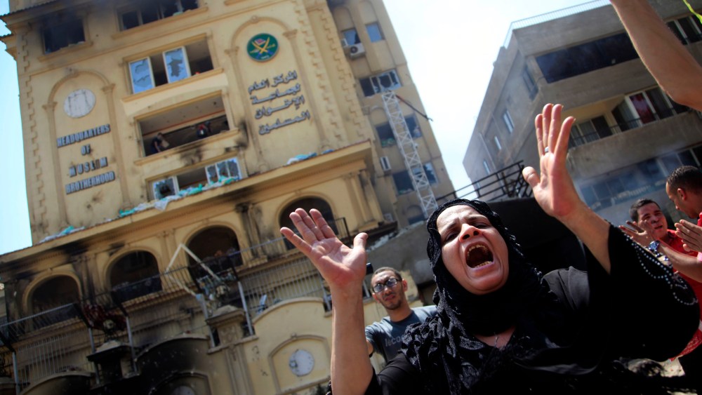 An Egyptian woman chants slogans, as protesters ransack the Muslim Brotherhood headquarters in the Muqattam district in Cairo, Monday, July 1, 2013. Protesters stormed and ransacked the headquarters of President Mohammed Morsi's Muslim Brotherhood...