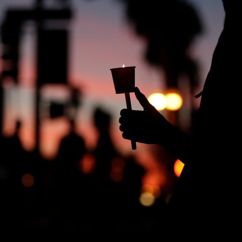 Cathleen Garcia holds a candle during a vigil to honor shooting victims on Dec. 7, 2015, in San Bernardino, Calif. (Photo by Jae C. Hong/AP)
