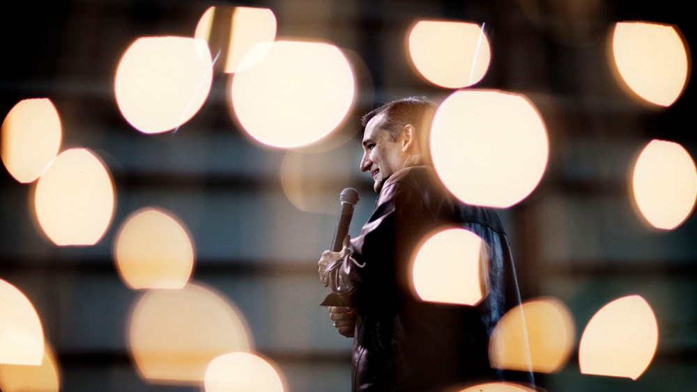 Republican presidential candidate, Sen. Ted Cruz, R-Texas, is seen through Christmas lights as he speaks during a campaign event, Dec. 18, 2015, in Kennesaw, Ga. (Photo by David Goldman/AP)