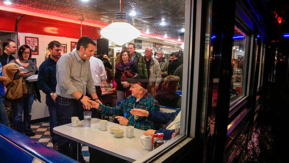 Republican Presidential candidate Sen. Ted Cruz, R-Texas, shakes the hand of Rex Haner, of Moorhead, Iowa, as he campaigns at Penny's Diner in Missouri Valley, Iowa, Jan. 4, 2016. (Photo by Nati Harnik/AP)