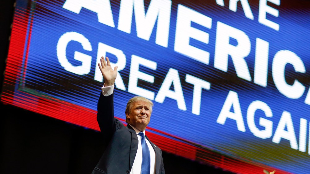 Republican presidential candidate, businessman Donald Trump waves has he arrives for a campaign rally, Feb. 8, 2016, in Manchester, N.H. (Photo by David Goldman/AP)