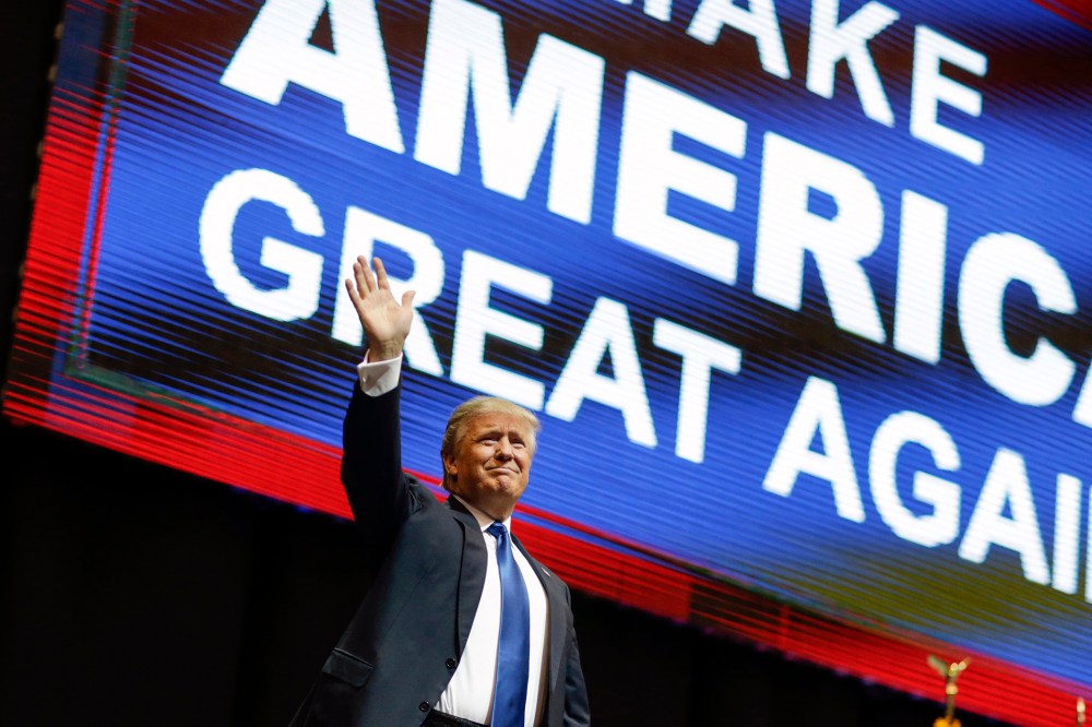 Republican presidential candidate, businessman Donald Trump waves has he arrives for a campaign rally, Feb. 8, 2016, in Manchester, N.H. (Photo by David Goldman/AP)