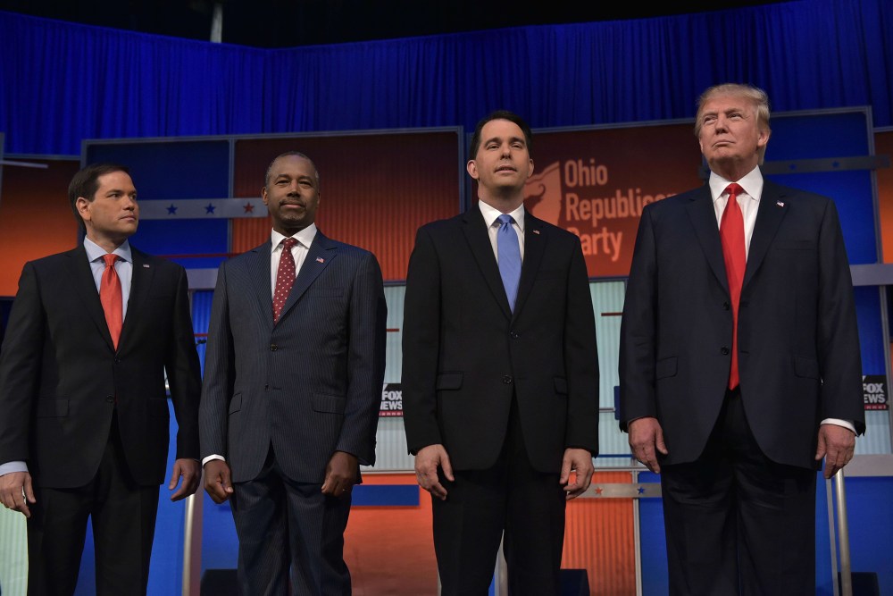 Florida Senator Marco Rubio, retired neurosurgeon Ben Carson, Wisconsin Gov. Scott Walker, and real estate magnate Donald Trump return to the stage following a break in the Republican presidential primary debate on August 6, 2015 at the Quicken Loans Aren