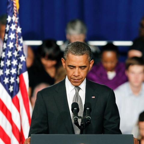 President Barack Obama takes a moment of silence for the events in Colorado during a campaign stop in Fort Myers, Florida.