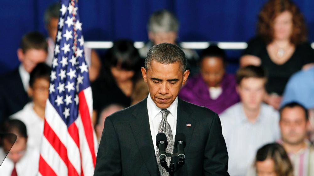 President Barack Obama takes a moment of silence for the events in Colorado during a campaign stop in Fort Myers, Florida.