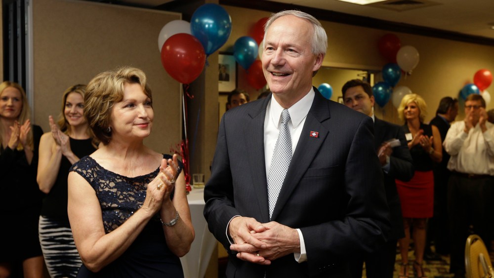 Asa Hutchinson, right, is applauded by his wife Susan and others as early vote totals are announced inLittle Rock, Ark., Tuesday, May 20, 2014.