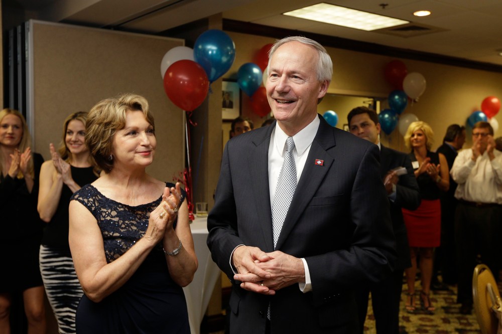 Asa Hutchinson, right, is applauded by his wife Susan and others as early vote totals are announced inLittle Rock, Ark., Tuesday, May 20, 2014.