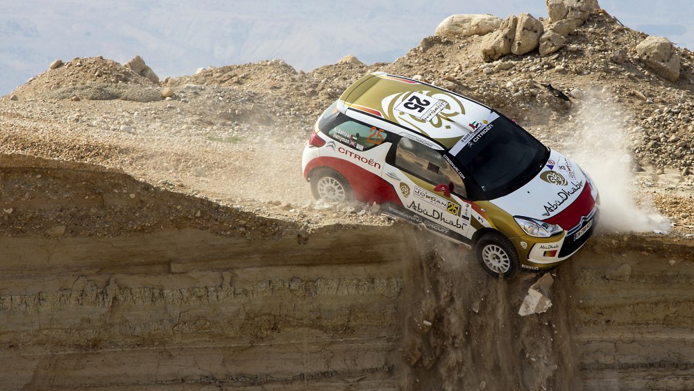 A car veers off a cliff during the first stage of the Jordan Rally in Sweimeh near the Dead Sea on May 10, 2013.