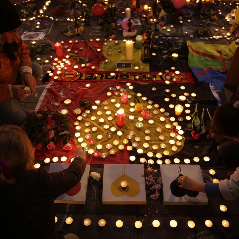People light candles in tribute to victims at a makeshift memorial in front of the stock exchange at the Place de la Bourse (Beursplein) in Brussels on March 22, 2016. (Photo by Kenzo Tribouillard/AFP/Getty)