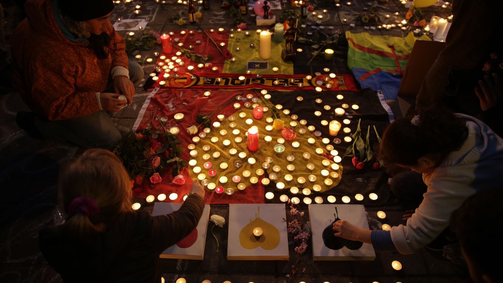 People light candles in tribute to victims at a makeshift memorial in front of the stock exchange at the Place de la Bourse (Beursplein) in Brussels on March 22, 2016. (Photo by Kenzo Tribouillard/AFP/Getty)
