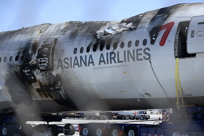 The wreckage of the Asiana Airlines Flight 214 is moved off site to a secure area away from the runway at San Francisco International Airport in San Francisco, California, July 12, 2013. (Photo by John G. Mabanglo/EPA)