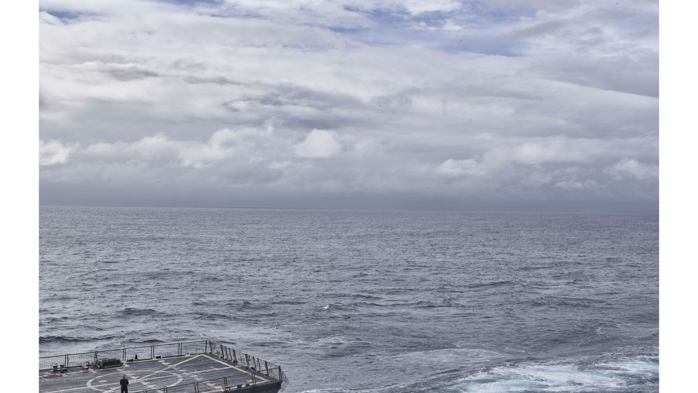 A U.S. Navy sailor stands on the deck of the USS Farragut as his ship approaches the USS Bataan to practice ‘UNREP’, or underway replenishment of cargo and fuel on May 24, 2016. (Photo by Balazs Gardi for MSNBC)