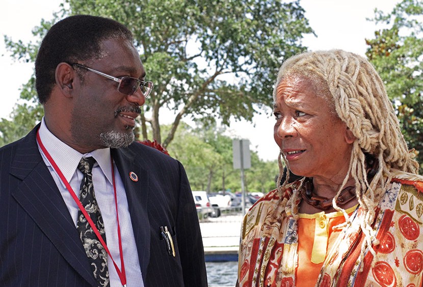 Thomas Battles (L), Southeast Regional director of the Department of Justice's Community Relations Service, talks with community activist Francis Oliver (R), outside of the Seminole County courthouse on Monday where George Zimmerman is being tried for...