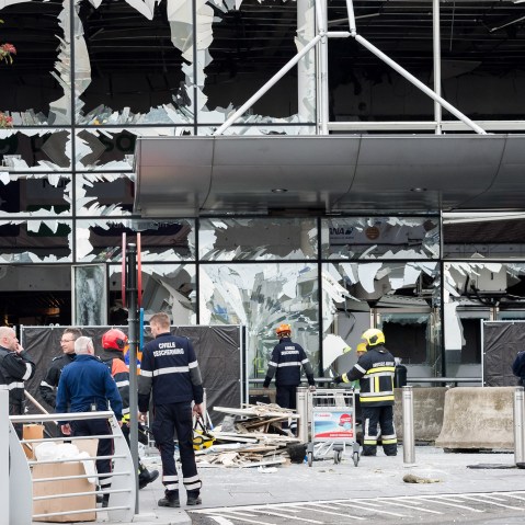 Police and other emergency workers stand in front of the damaged Zaventem Airport terminal in Brussels on March 23, 2016. (Photo by Geert Vanden Wijngaert/AP)