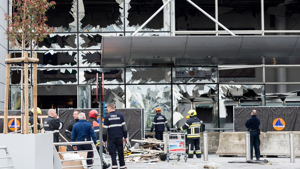 Police and other emergency workers stand in front of the damaged Zaventem Airport terminal in Brussels on March 23, 2016. (Photo by Geert Vanden Wijngaert/AP)