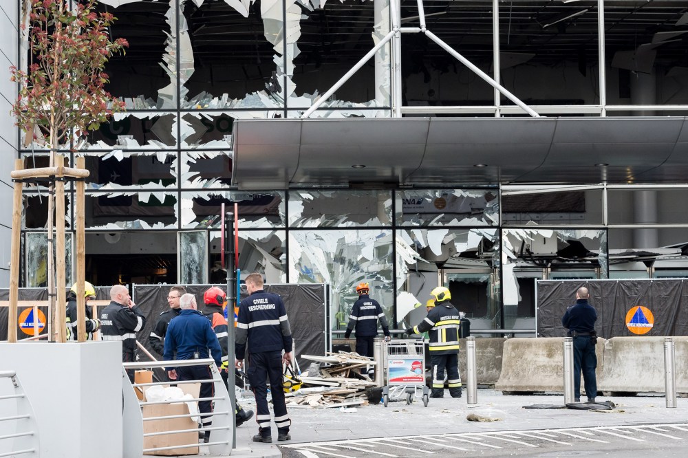 Police and other emergency workers stand in front of the damaged Zaventem Airport terminal in Brussels on March 23, 2016. (Photo by Geert Vanden Wijngaert/AP)