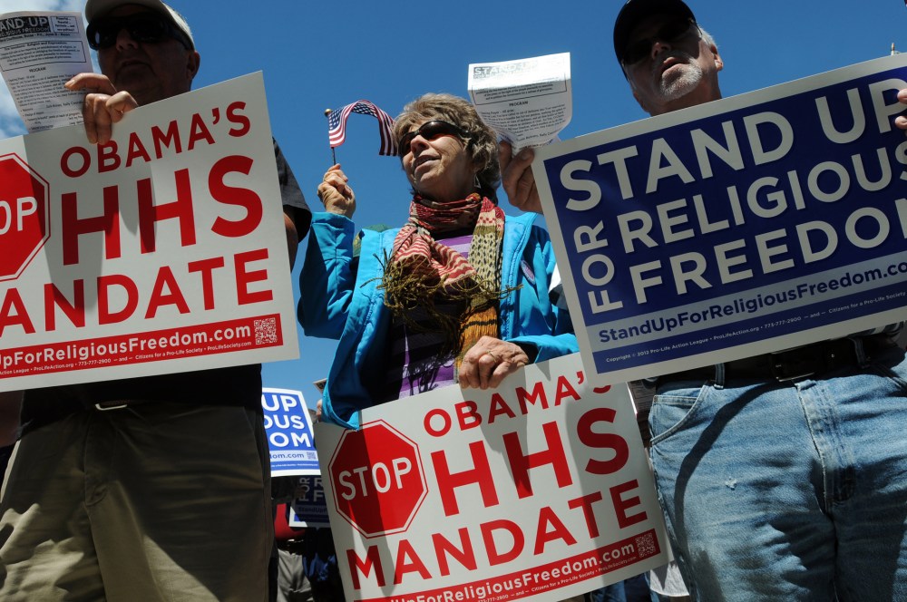 Protesters during a demonstration in opposition of the Obama administration's healthcare mandate for religious institutions, Friday, June 8, 2012 outside the James A McClure Federal Building in Boise, Idaho.