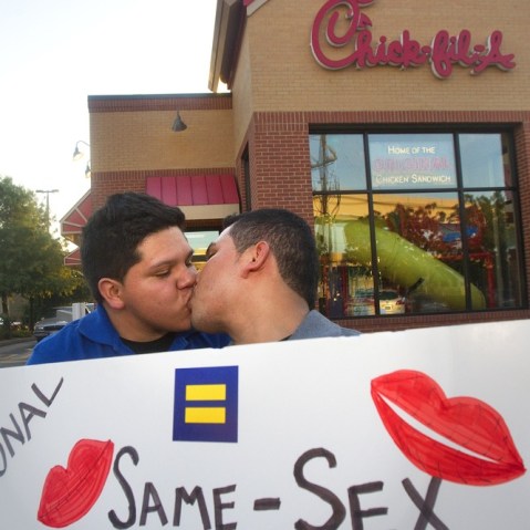 Miguel Martinez, left, kisses partner of five years, Sergio Andrade, right, during National Same Sex Kiss Day at Chick-fil-A in Houston on Aug. 3, 2012.
