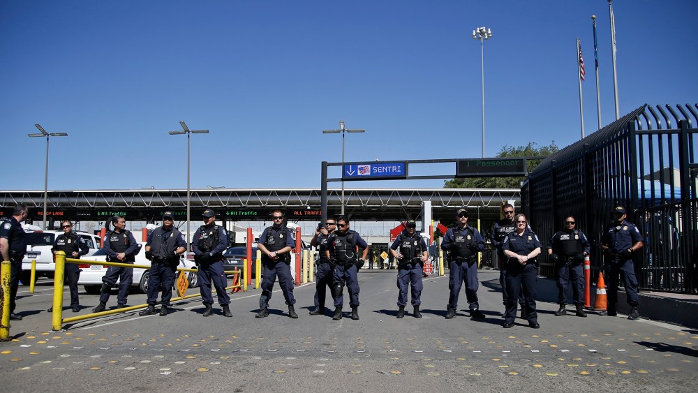 U.S. Customs and Border Protection officers block entry lanes into the United States as the group Border Dreamers and othersmarch toward the U.S. border, March 10, 2014, in Tijuana, Mexico.