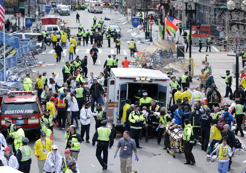 Medical workers aid injured people at the finish line of the 2013 Boston Marathon following an explosion in Boston on April 15, 2013. (Photo by Charles Krupa/AP Photo)