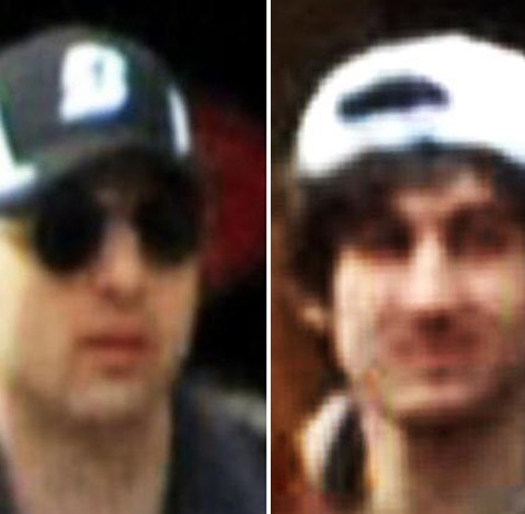 This combo of photos released by the FBI early Friday April 19, 2013, shows what the FBI is calling suspects number 1, left, and suspect number 2, right,  walking through the crowd in Boston on Monday, April 15, 2013, before the explosions at the...
