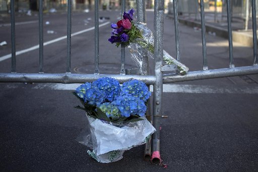 Flowers are seen at the barricaded entrance at Boylston Street near the finish line of the Boston Marathon in Boston, Massachusetts April 16, 2013. Two bombs packed with ball bearings tore through crowds near the finish line of the Boston Marathon,...