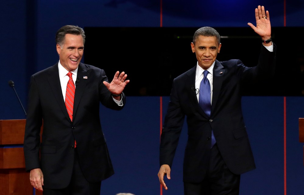 Republican presidential candidate Mitt Romney and President Barack Obama wave to the audience during the first presidential debate. (Photo: AP/Charlie Neibergall)
