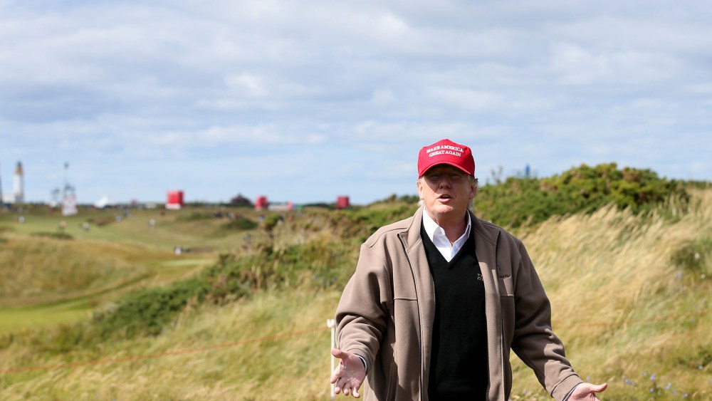Presidential contender Donald Trump gestures to the media on the 17th fairway on the first day of the Women's British Open golf championship on the Turnberry golf course in Turnberry, Scotland, July 30, 2015. (Photo by Scott Heppell/AP)