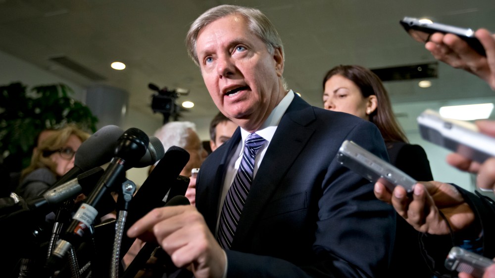 Sen. Lindsey Graham, R-S.C., a member of the Senate Armed Services Committee and the Senate Homeland Security Committee, center, accompanied by fellow Senate Armed Services Committee member, Sen. Kelly Ayotte, R-N.H.,, right, gestures while speaking to...