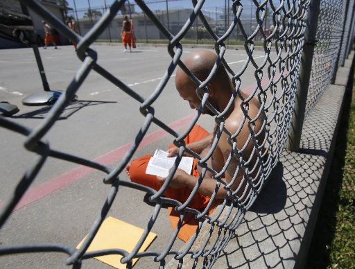 Inmate Curtis Colvard Sr. reads a Bible in the exercise yard of Sacramento County's Rio Cosumnes Correctional Center in Elk Grove, Calif., Thursday, May 30, 2013.  A report by the California Little Hoover Commission  says Gov. Jerry Brown's prison...
