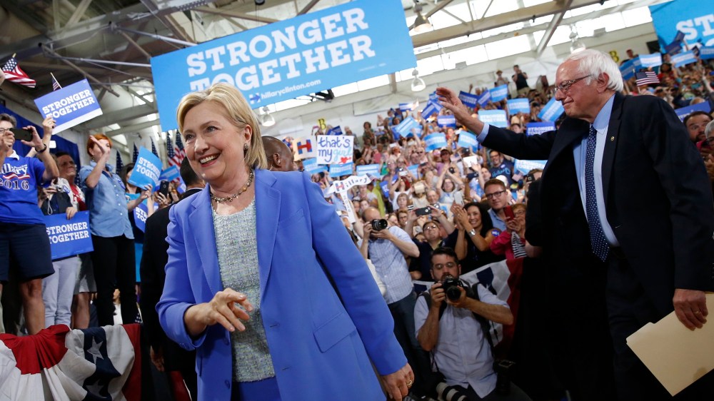 Democratic presidential candidate Hillary Clinton, followed by Sen. Bernie Sanders, I-Vt. arrives for a rally in Portsmouth, N.H., July 12, 2016. (Photo by Andrew Harnik/AP)