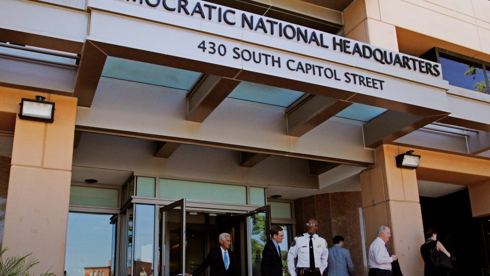 People stand outside the Democratic National Committee (DNC) headquarters in Washington, Tuesday, June 14, 2016. (Photo by Paul Holston/AP)