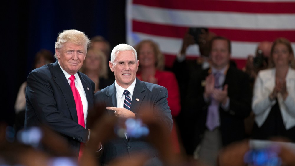 Republican presidential candidate Donald Trump, left, shakes hands with vice presidential candidate Gov. Mike Pence, R-Ind., during a town hall, July 25, 2016, in Roanoke, Va. (Photo by Evan Vucci/AP)