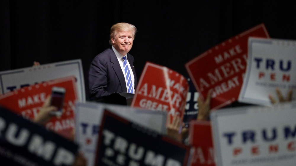Republican presidential candidate Donald Trump takes the stage at a rally, Wednesday, Sept. 28, 2016, in Council Bluffs, Iowa. (Photo by John Locher/AP)