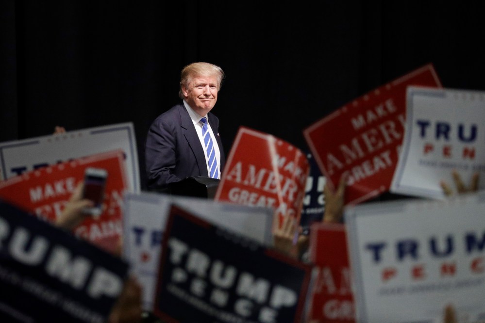 Republican presidential candidate Donald Trump takes the stage at a rally, Wednesday, Sept. 28, 2016, in Council Bluffs, Iowa. (Photo by John Locher/AP)